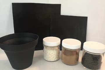 two black sheets, three jars of material and a flower pot