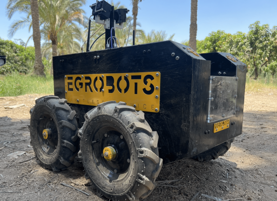 The robot: a black metallic box on four thick and sturdy wheels, with a couple of cameras on top. Yellow sign on the side reads "Egrobots"