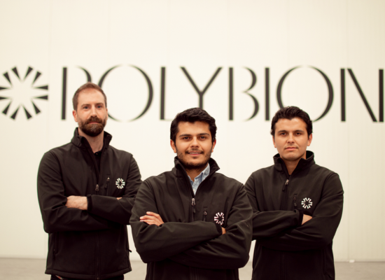 three men standing in front of the Polybion logo