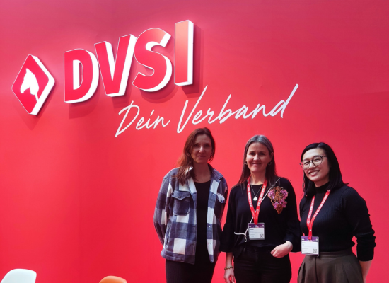 three women standing next to a logo saying DVSI