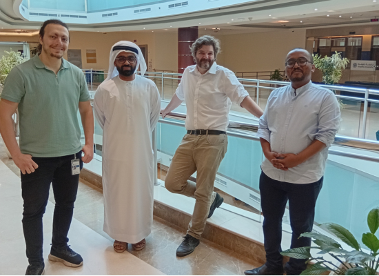 four men posing for the camera